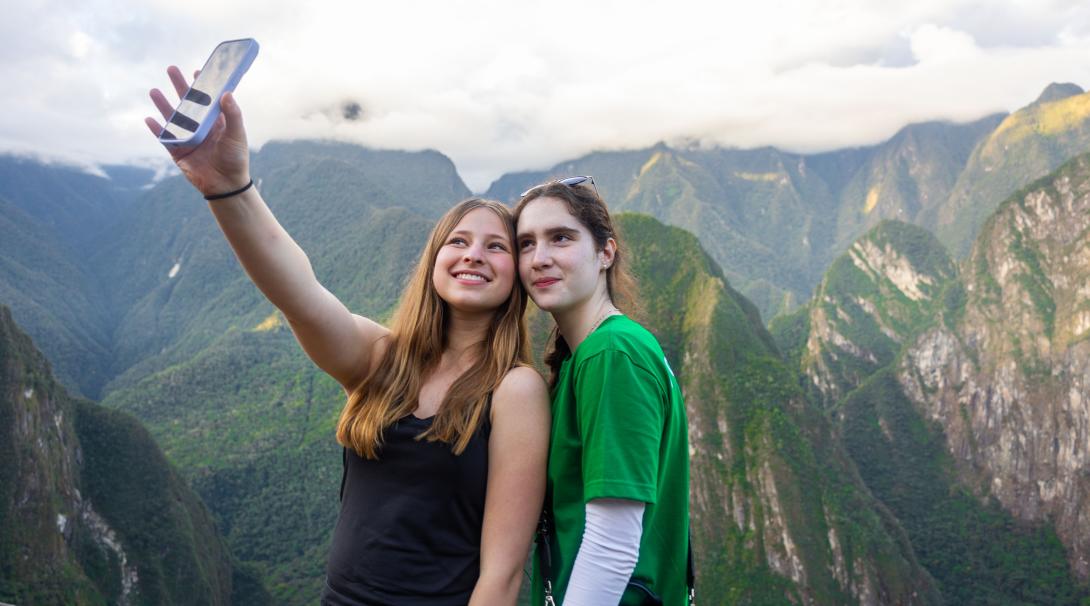 Two high school special volunteers posing for a selfie during their trip to Machu Picchu.